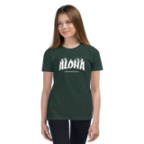 Preteen model wearing a Aloha Tribe Hawaii T-shirt that has a Hawaii themed graphic logo on the front.