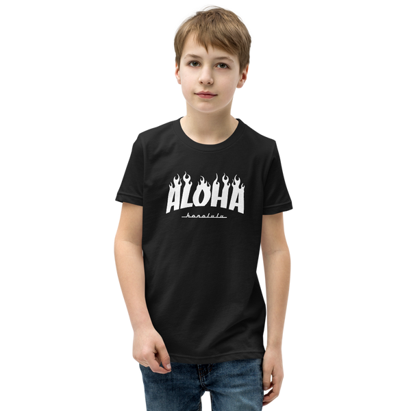 Preteen model wearing a Aloha Tribe Hawaii T-shirt that has a Hawaii themed graphic logo on the front.