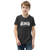 Preteen model wearing a Aloha Tribe Hawaii T-shirt that has a Hawaii themed graphic logo on the front.