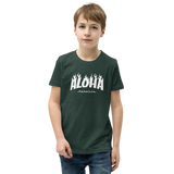 Preteen model wearing a Aloha Tribe Hawaii T-shirt that has a Hawaii themed graphic logo on the front.
