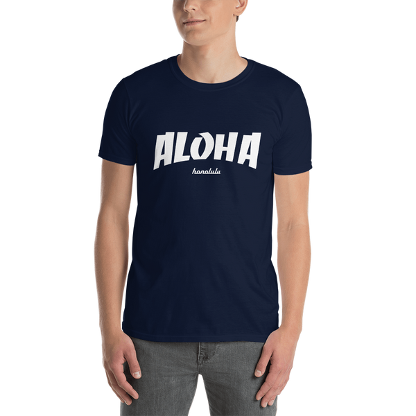 A male model wearing a Aloha Tribe Hawaii T-shirt that has Hawaii themed graphic logos on the front.