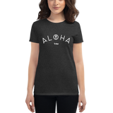 Young female wearing a Aloha Tribe Hawaii shirt that has a Hawaii themed graphic logo on the front.