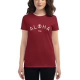 Young female wearing a Aloha Tribe Hawaii shirt that has a Hawaii themed graphic logo on the front.