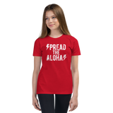 Preteen model wearing a Aloha Tribe Hawaii T-shirt that has a Hawaii themed graphic logo on the front.
