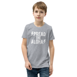 Preteen model wearing a Aloha Tribe Hawaii T-shirt that has a Hawaii themed graphic logo on the front.
