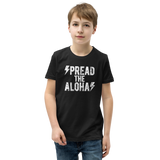 Preteen model wearing a Aloha Tribe Hawaii T-shirt that has a Hawaii themed graphic logo on the front.