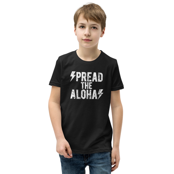 Preteen model wearing a Aloha Tribe Hawaii T-shirt that has a Hawaii themed graphic logo on the front.