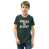 Preteen model wearing a Aloha Tribe Hawaii T-shirt that has a Hawaii themed graphic logo on the front.