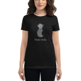Young female wearing a Aloha Tribe Hawaii shirt that has a Hawaii themed graphic logo on the front.