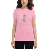 Young female wearing a Aloha Tribe Hawaii shirt that has a Hawaii themed graphic logo on the front.