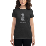 Young female wearing a Aloha Tribe Hawaii shirt that has a Hawaii themed graphic logo on the front.