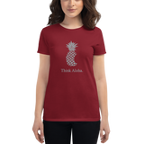 Young female wearing a Aloha Tribe Hawaii shirt that has a Hawaii themed graphic logo on the front.
