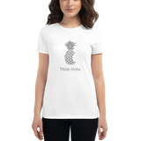 Young female wearing a Aloha Tribe Hawaii shirt that has a Hawaii themed graphic logo on the front.