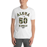Young male adult wearing a Alter Ego Hawaii T-shirt that has a Hawaii themed graphic logo on the front.