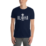 Young male adult wearing a Alter Ego Hawaii T-shirt that has a Hawaii themed graphic logo on the front.