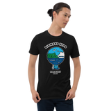 Young male adult wearing a Alter Ego Hawaii T-shirt that has a Hawaii themed graphic logo on the front.