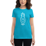 Young female wearing a Alter Ego Hawaii shirt that has a Hawaii themed graphic logo on the front.