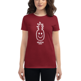 Young female wearing a Alter Ego Hawaii shirt that has a Hawaii themed graphic logo on the front.