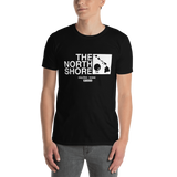 Young male adult wearing a Alter Ego Hawaii T-shirt that has a Hawaii themed graphic logo on the front.