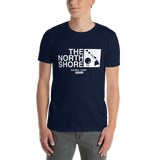 Young male adult wearing a Alter Ego Hawaii T-shirt that has a Hawaii themed graphic logo on the front.