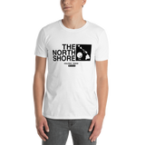 Young male adult wearing a Alter Ego Hawaii T-shirt that has a Hawaii themed graphic logo on the front.