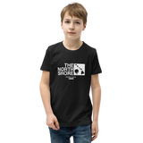 Preteen model wearing a Alter Ego Hawaii T-shirt that has a Hawaii themed graphic logo on the front.