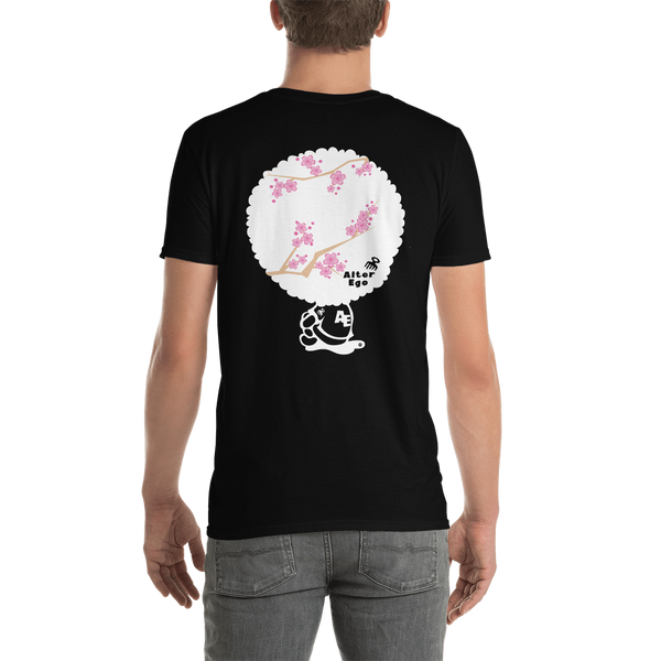 Young male adult wearing a Alter Ego Hawaii T-shirt that has a Hawaii themed graphic logo on the front.