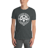 Young male adult wearing a Alter Ego Hawaii T-shirt that has a Hawaii themed graphic logo on the front.