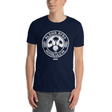Young male adult wearing a Alter Ego Hawaii T-shirt that has a Hawaii themed graphic logo on the front.