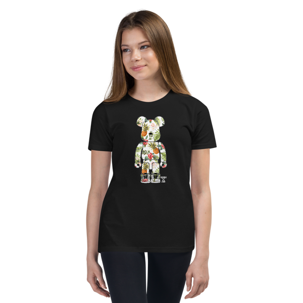 Preteen model wearing a Rhythm Arts Hawaii T-shirt that has a urban street themed graphic logo on the front.