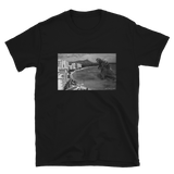 Young male wearing a Rhythm Arts Hawaii T-shirt that has a urban street themed graphic logo on the front.