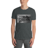 Young male wearing a Rhythm Arts Hawaii T-shirt that has a urban street themed graphic logo on the front.