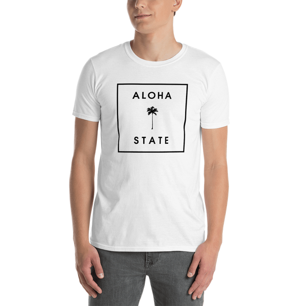 Young male wearing a Aloha Tribe T-shirt that has a Hawaii themed graphic logo on the front.