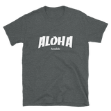 A male model wearing a Aloha Tribe Hawaii T-shirt that has Hawaii themed graphic logos on the front.