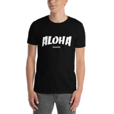 A male model wearing a Aloha Tribe Hawaii T-shirt that has Hawaii themed graphic logos on the front.