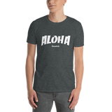 A male model wearing a Aloha Tribe Hawaii T-shirt that has Hawaii themed graphic logos on the front.