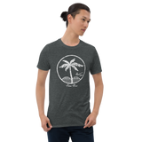 Young male wearing a Aloha Tribe T-shirt that has a Hawaii themed graphic logo on the front.