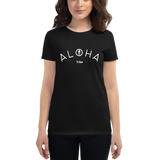 Young female wearing a Aloha Tribe Hawaii shirt that has a Hawaii themed graphic logo on the front.