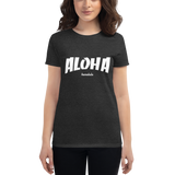 Young female wearing a Aloha Tribe Hawaii shirt that has a Hawaii themed graphic logo on the front.