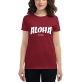 Young female wearing a Aloha Tribe Hawaii shirt that has a Hawaii themed graphic logo on the front.