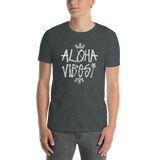 Young male wearing a Aloha Tribe T-shirt that has a Hawaii themed graphic logo on the front.