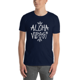 Young male wearing a Aloha Tribe T-shirt that has a Hawaii themed graphic logo on the front.