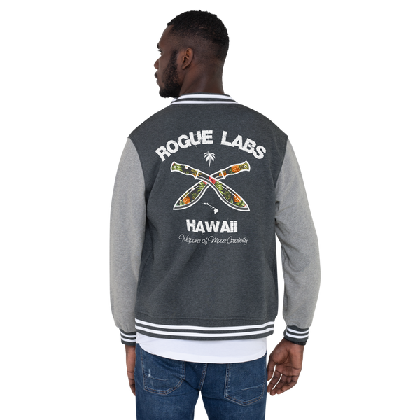 Young model wearing a Rogue Labs Hawaii letterman jacket that has a urban street themed graphic logo on the front.